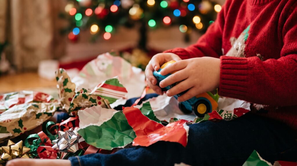 christmas gifts for kids - child opening a toy