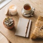 Best gifts under $25 — a candle, mug of tea, succulent and notebook flat lay